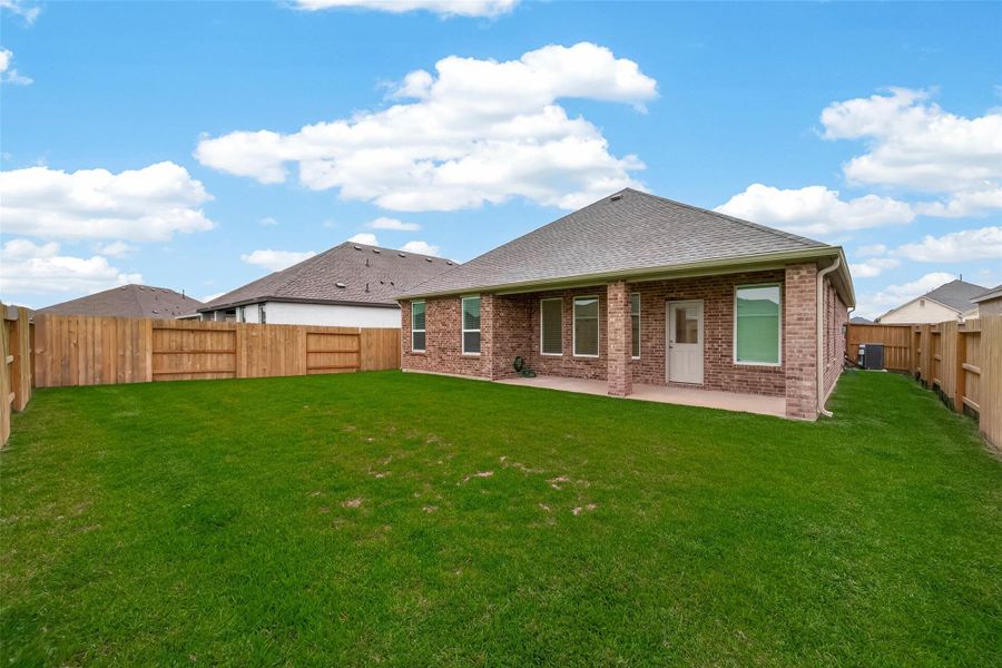 Enjoy a fully fenced backyard with plenty of green space and a covered patio ideal for relaxing or entertaining outdoors.