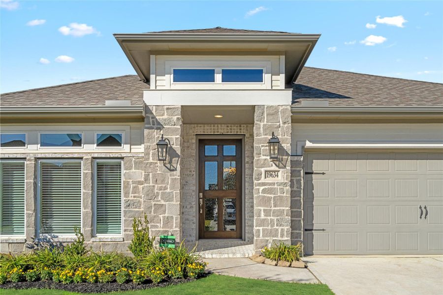 Close-up of the elegant front door and architectural stone entry detailing.