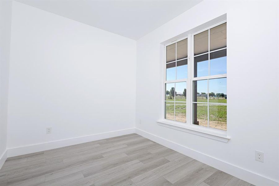 Unfurnished room featuring light wood-type flooring