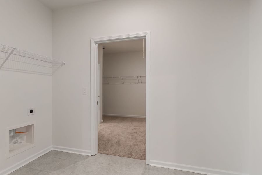Laundry room with access to the primary walk-in closet.
