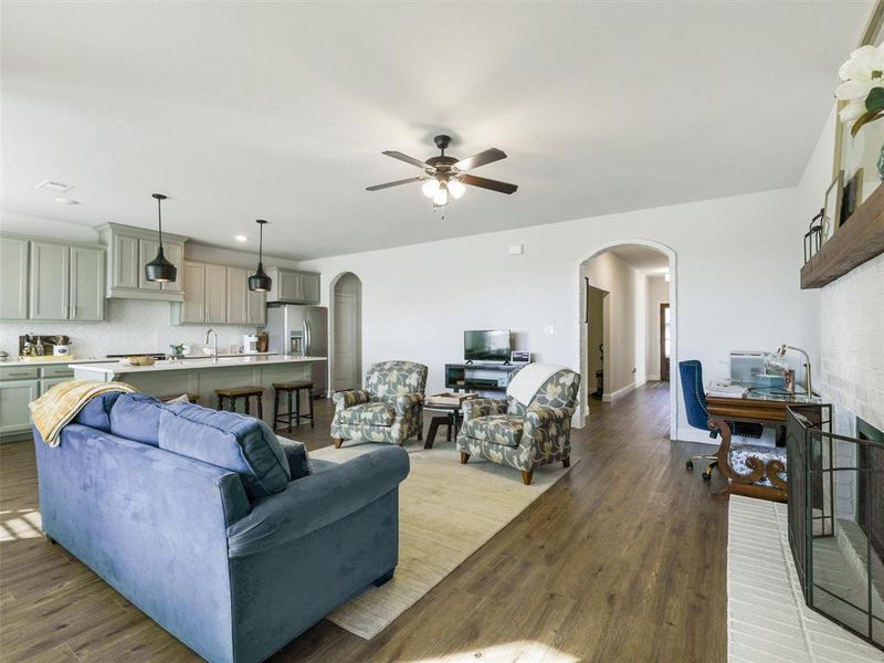 Living room with ceiling fan and hardwood / wood-style floors