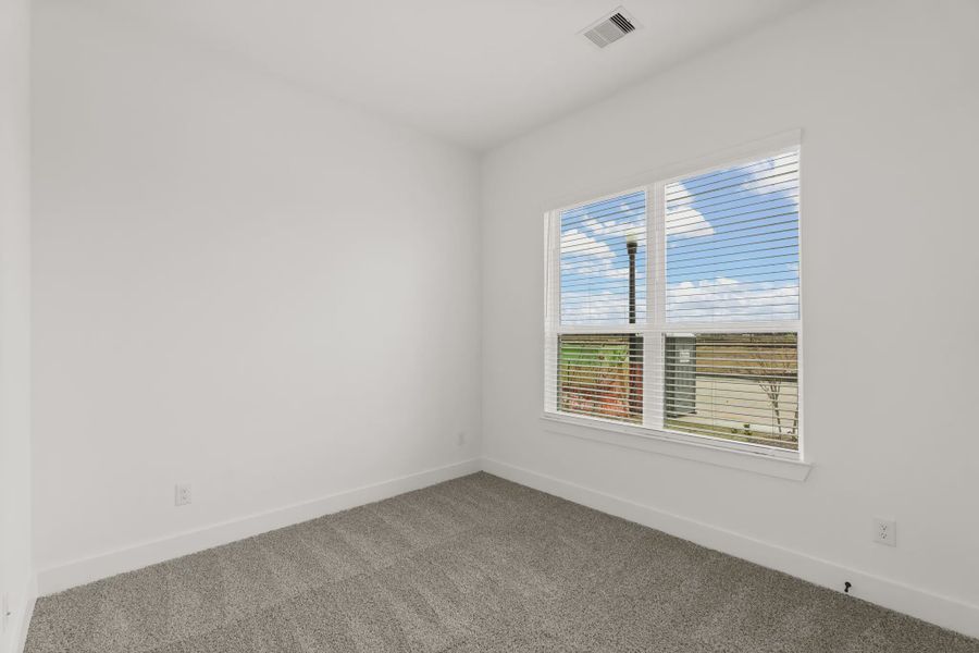 Representative unfurnished interior of a home built from the Pinehurst by Chesmar Homes in Riceland Alley Loads, Mont Belvieu (Image 14).