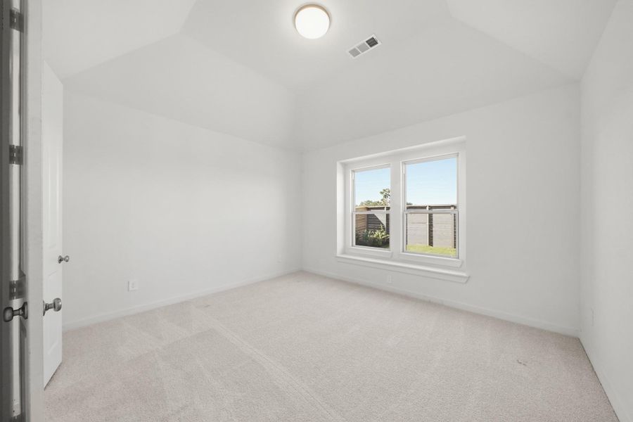 A serene primary bedroom with tall ceilings and a large window, creating a bright and relaxing retreat A serene primary bedroom with tall ceilings and a large window, creating a bright and relaxing retreat