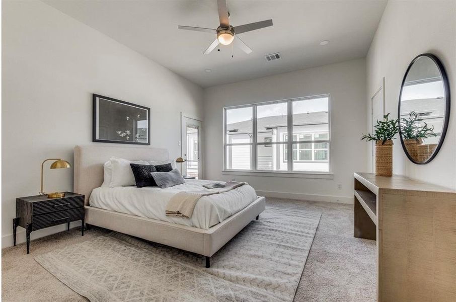 Carpeted bedroom with ceiling fan