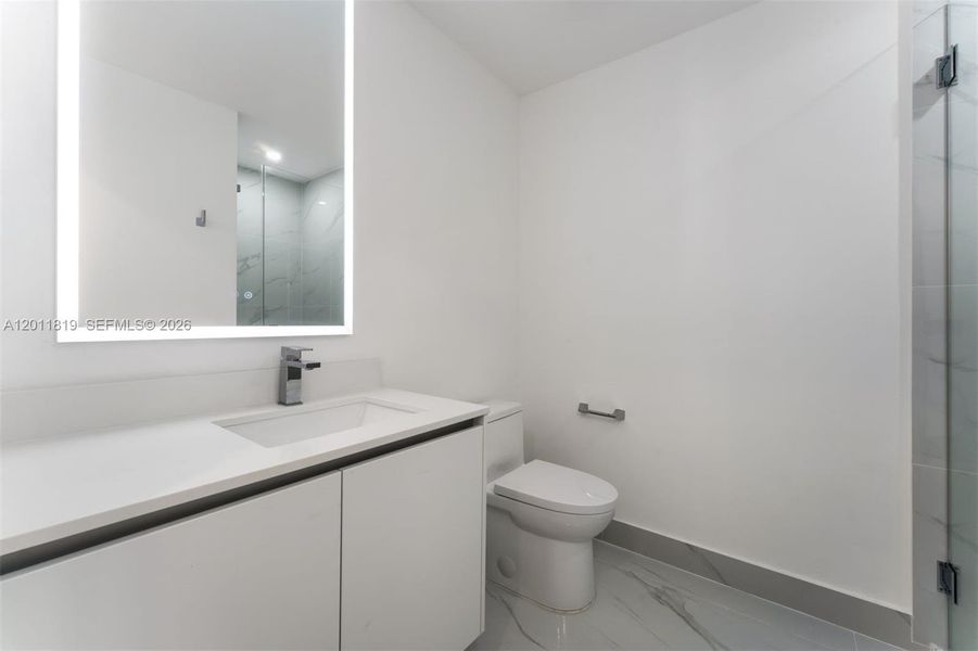 Elegant secondary bathroom with high-end European fixtures, modern vanity, and curated finishes consistent with Aria Reserve’s luxury design standards.