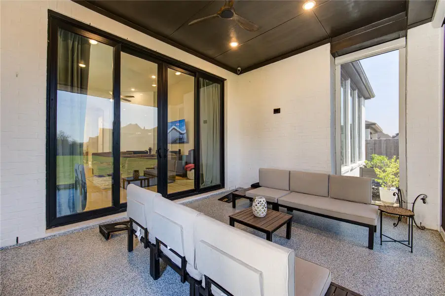 Access the Patio Through Elegant Floor-to-Ceiling Windows For a Seamless Indoor-Outdoor Experience
