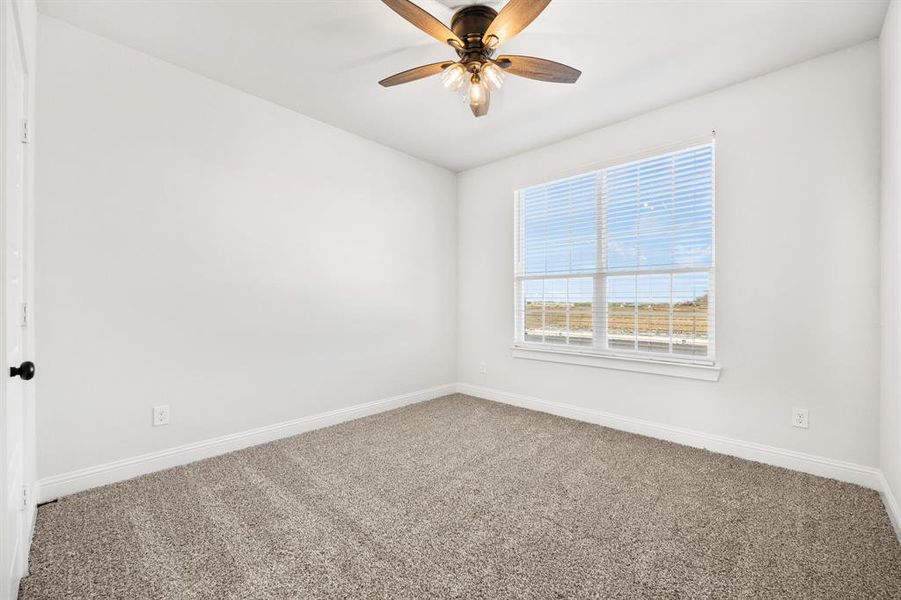 Spare room with carpet and ceiling fan