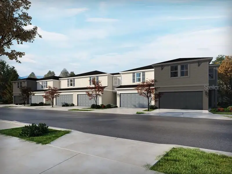 Front exterior of a new home in The Meadow at Crossprairie Townes, St. Cloud, FL, highlighting curb appeal (Image 1). Front exterior of a new home in The Meadow at Crossprairie Townes, St. Cloud, FL, highlighting curb appeal (Image 1).