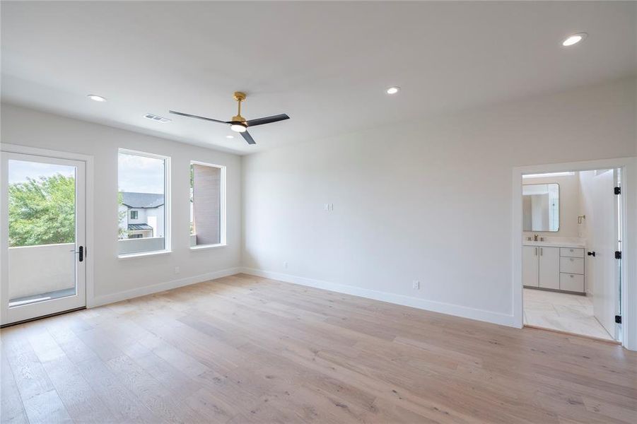 Spare room with sink, ceiling fan, and light wood-type flooring