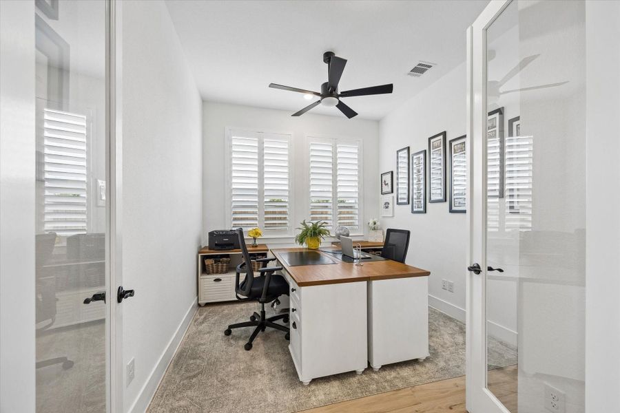 The bright and spacious home office features abundant natural light while creating an inviting and functional workspace.