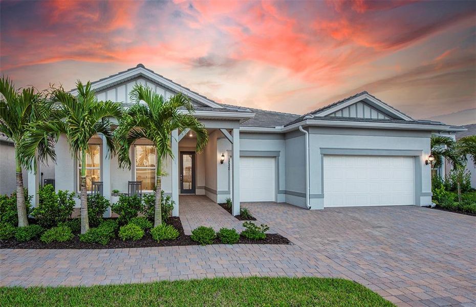 Front exterior of a new home in BeachWalk by Manasota Key, Englewood, FL, highlighting curb appeal (Image 1).