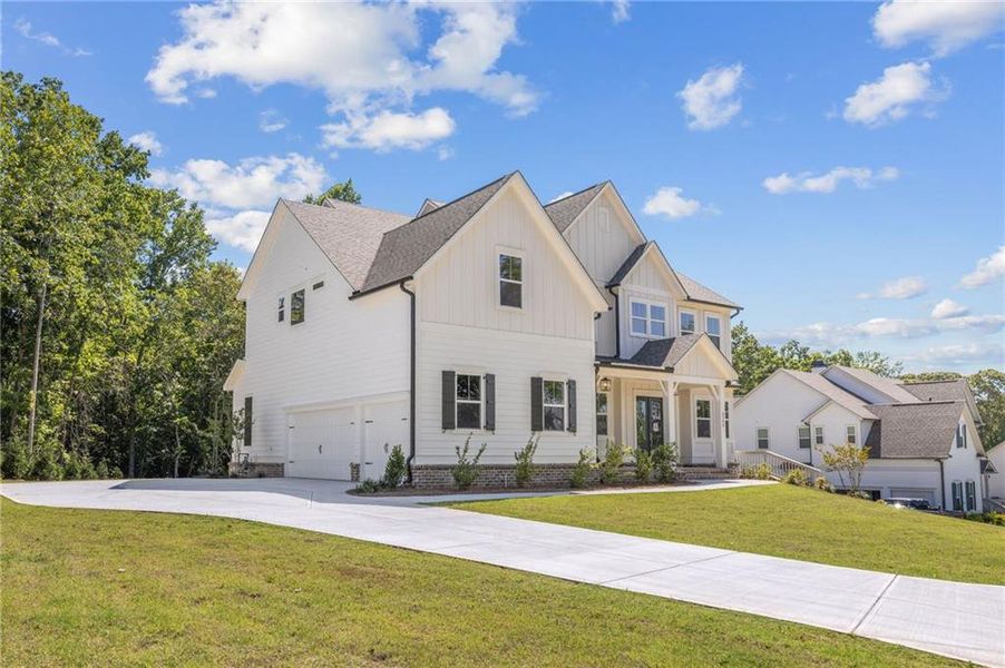 Front exterior of a new home in Chattahoochee Reserve, Cumming, GA, highlighting curb appeal (Image 32).