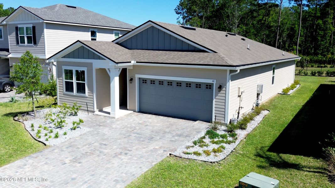 Front exterior of a new home in Seasons at TrailMark, St. Augustine, FL, highlighting curb appeal (Image 32).