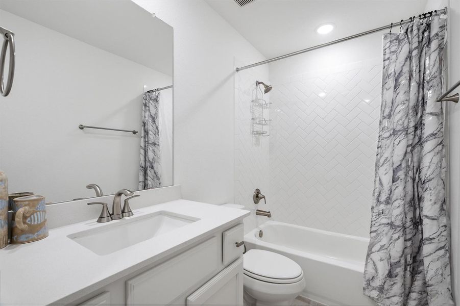 This bathroom features a single-sink vanity, a shower/tub combo, and a toilet — a practical and stylish space designed for everyday comfort.