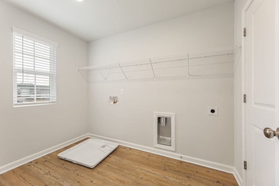 A room with a wood floor and white walls.