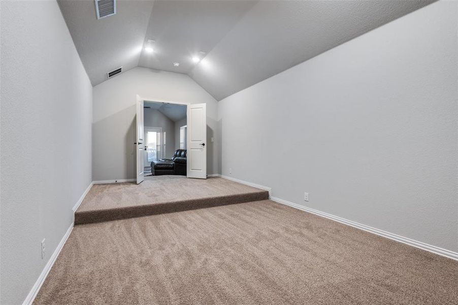 Bonus room with carpet and vaulted ceiling Bonus room with carpet and vaulted ceiling