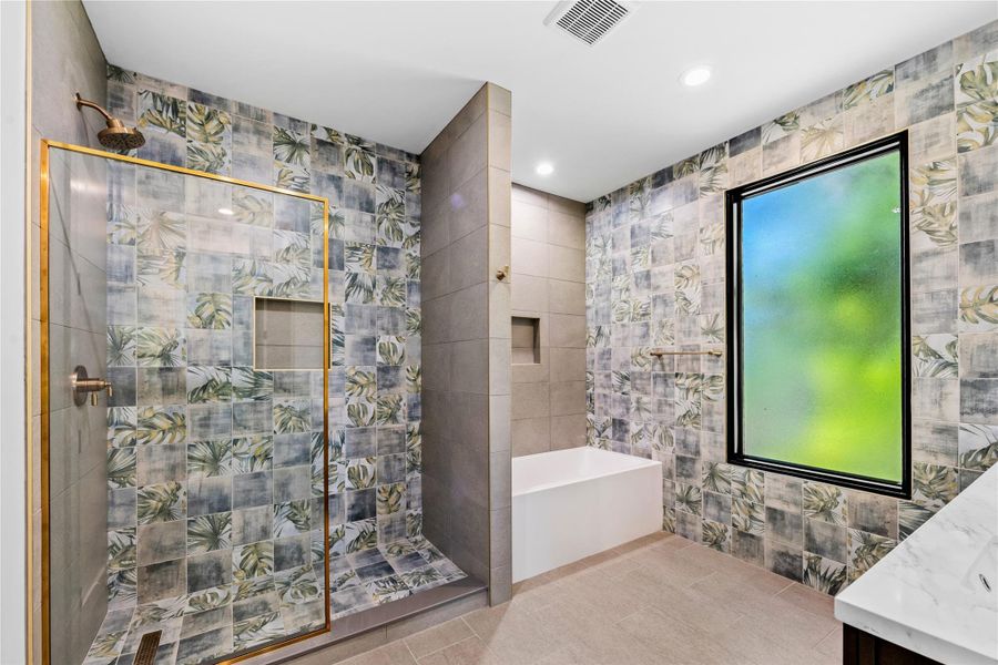 Full bath with tile walls, vanity, a garden tub, recessed lighting, and tile patterned floors