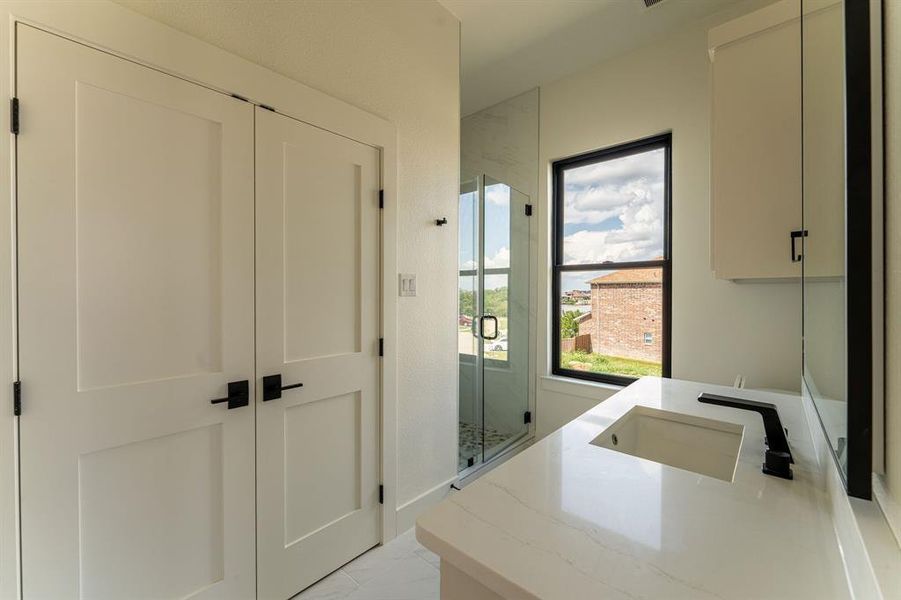Full bath with a stall shower and double vanity