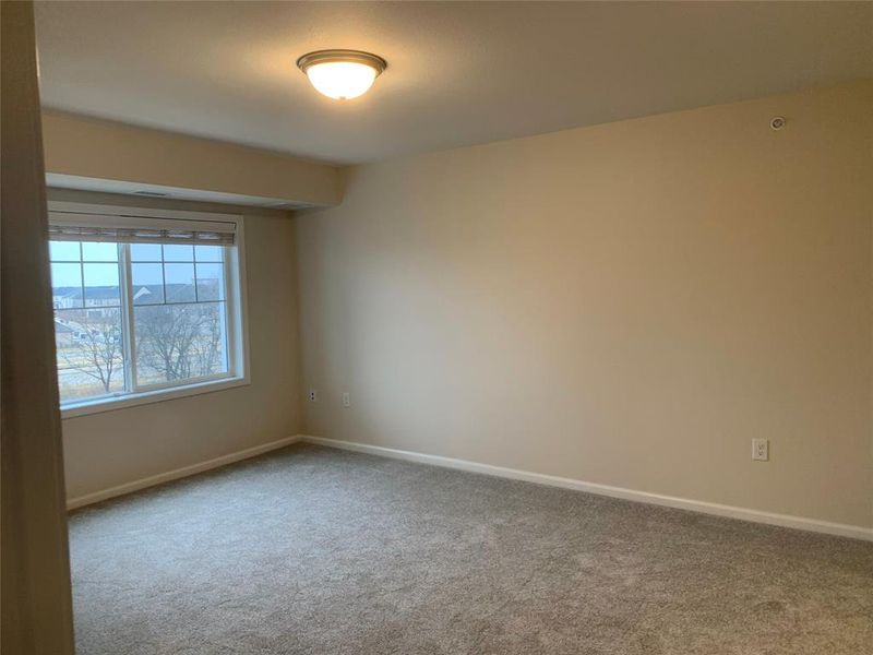 Carpeted room featuring baseboards