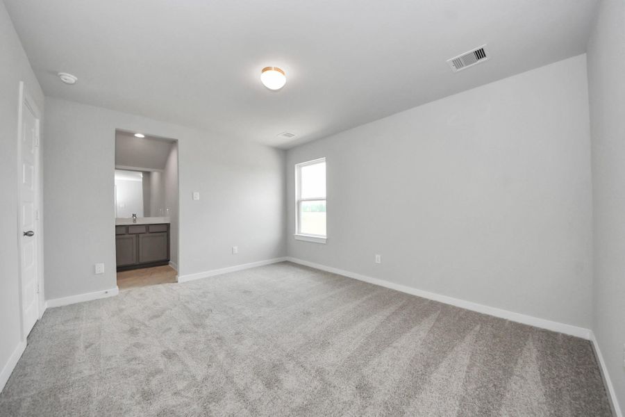 Generously sized secondary bedrooms featuring spacious closets, soft and inviting carpeting underfoot, large windows allowing plenty of natural light, and the added touch of privacy blinds for your personal retreat. Sample photo of completed home with similar floor plan. Actual colors and selections may vary.