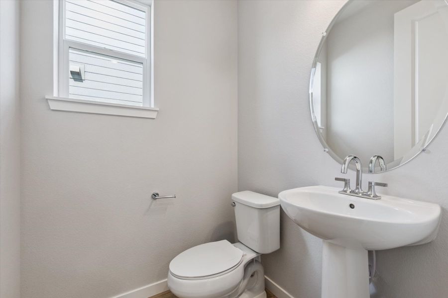 A bathroom with a sink and toilet.