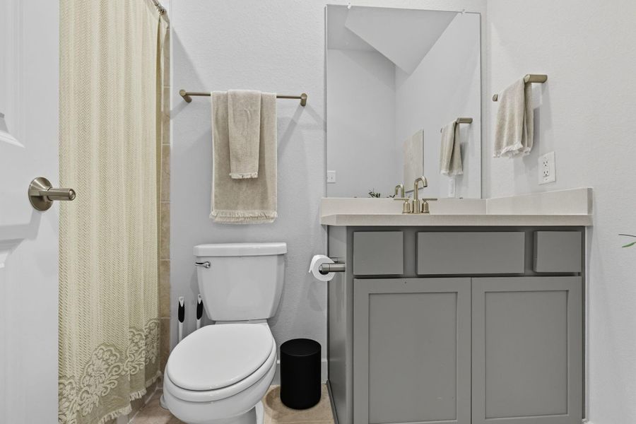 This downstairs full bath features a walk in shower and is conveniently located near the guest room.