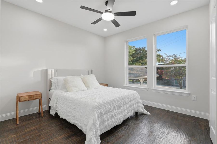 Room featuring wood-finish flooring, recessed lighting, and a ceiling fan with integrated lighting Room featuring wood-finish flooring, recessed lighting, and a ceiling fan with integrated lighting