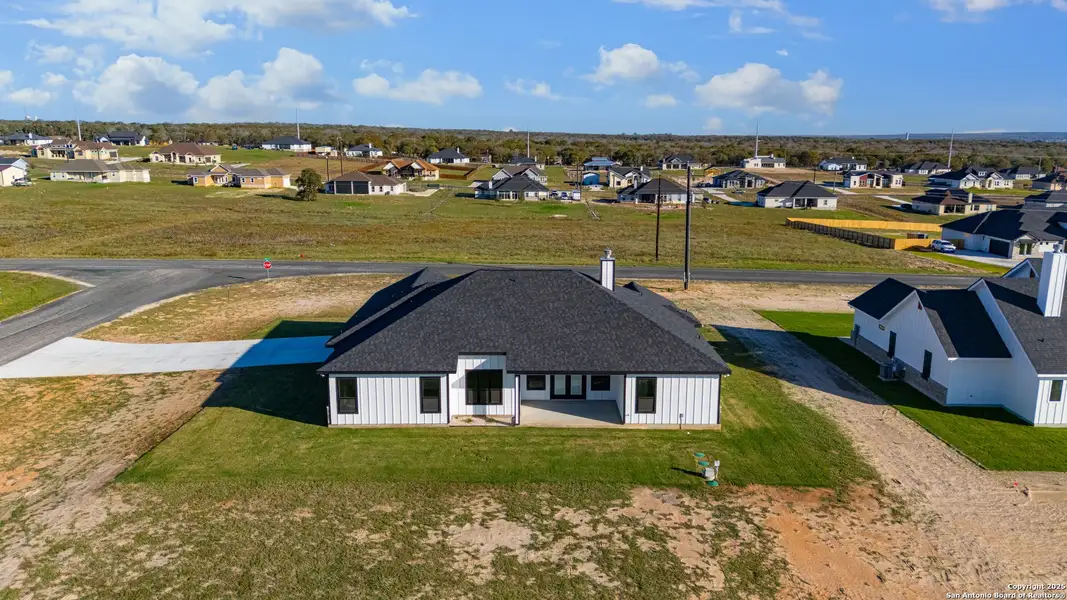 Front exterior of a new home in , La Vernia, TX, highlighting curb appeal (Image 1).