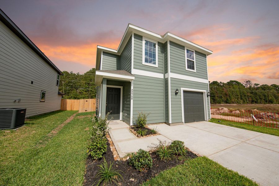 Front exterior of a new home in Townsend Reserve, Splendora, TX, highlighting curb appeal (Image 15). Front exterior of a new home in Townsend Reserve, Splendora, TX, highlighting curb appeal (Image 15).