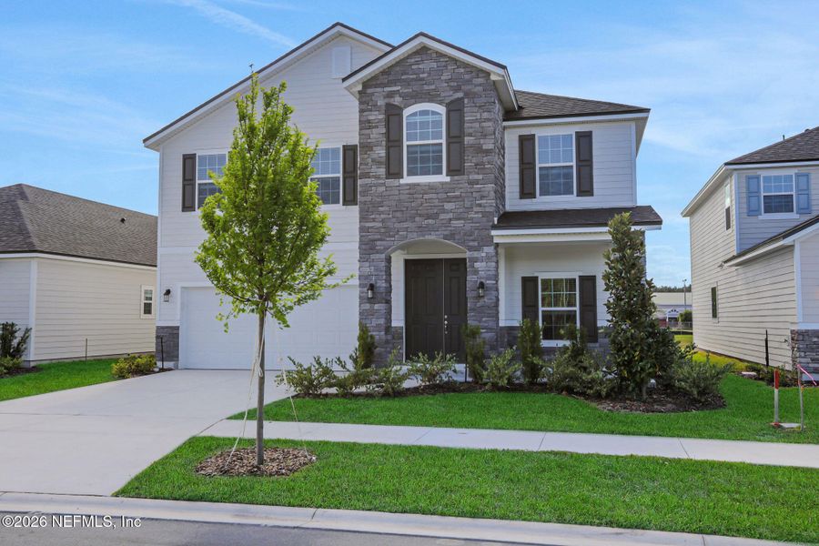 Front exterior of a new home in Amberly, Green Cove Springs, FL, highlighting curb appeal (Image 25).