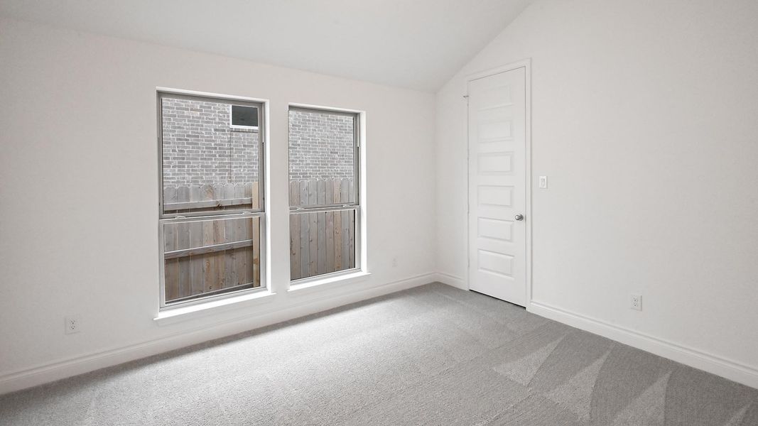 Unfurnished room with carpet, vaulted ceiling, and baseboards