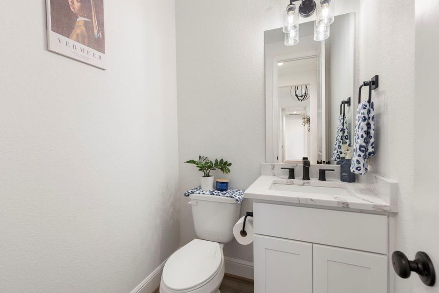 The guest powder room is conveniently located near the MUD room.