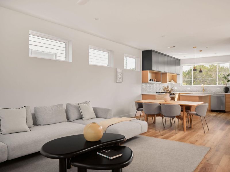 Living area featuring light wood finished floors and recessed lighting