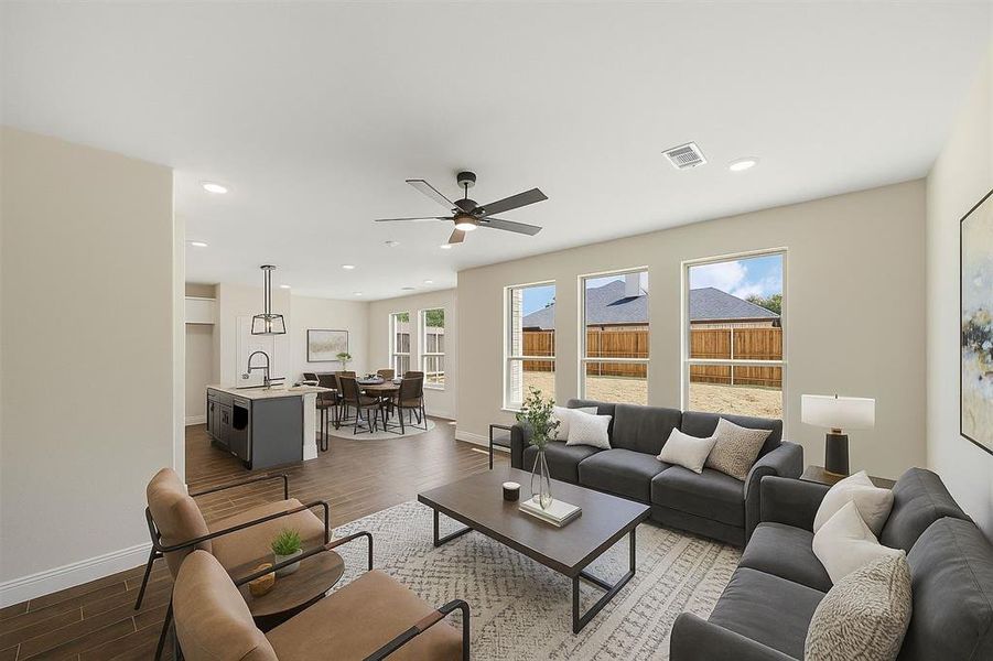 Virtually staged - Living area featuring dark wood-style flooring, recessed lighting, and ceiling fan Virtually staged - Living area featuring dark wood-style flooring, recessed lighting, and ceiling fan