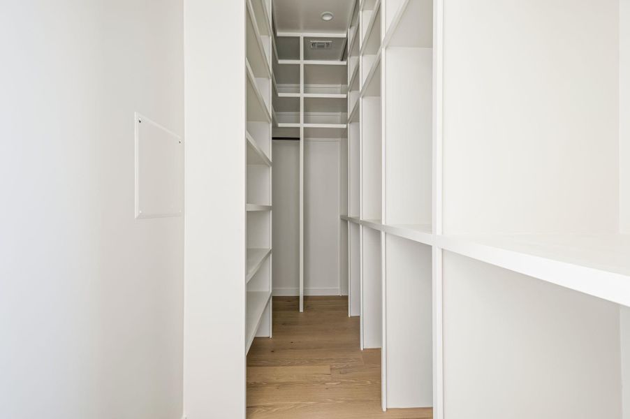 Floor-to-ceiling built-ins maximize storage potential above warm hardwood flooring.