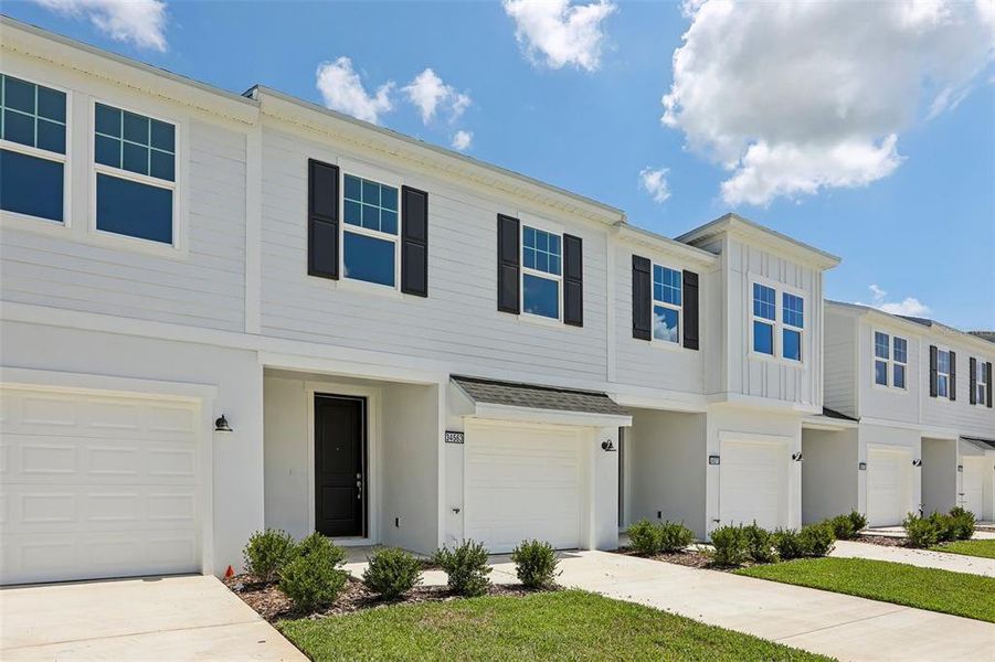Front exterior of a new home in Twin Oaks, Zephyrhills, FL, highlighting curb appeal (Image 16).