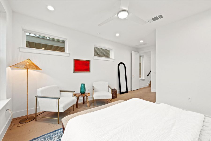 Hardwood floors and clean white walls offer a neutral canvas in this tranquil bedroom, ideal for peaceful slumber. Hardwood floors and clean white walls offer a neutral canvas in this tranquil bedroom, ideal for peaceful slumber.