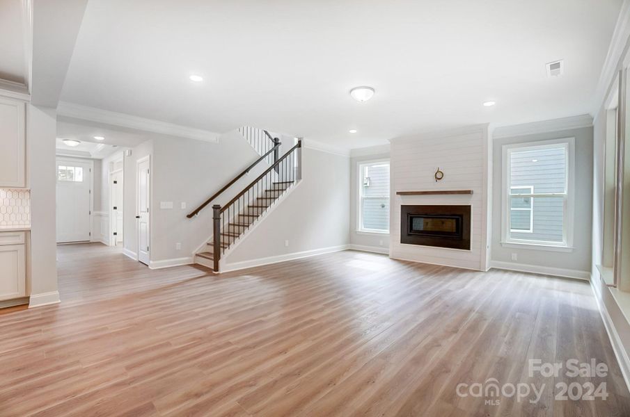 Open Living Room with Cosmo Fireplace and Shiplap wall