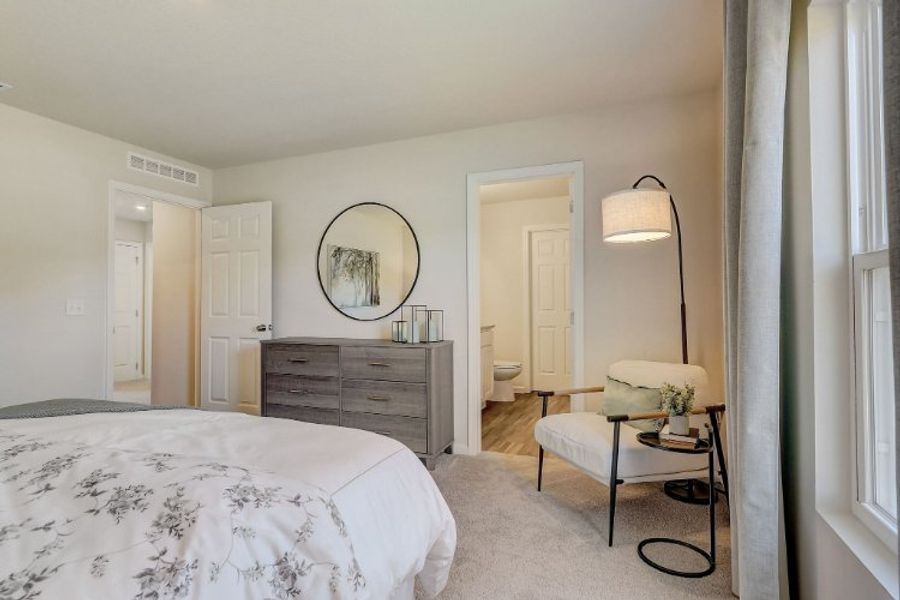 A bedroom with a bed and a table. A bedroom with a bed and a table.