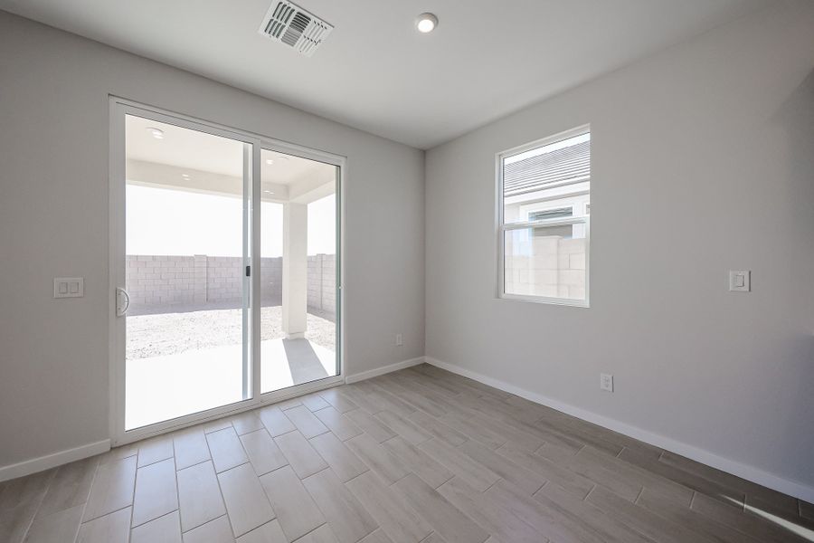 A room with a glass door and a wood floor.