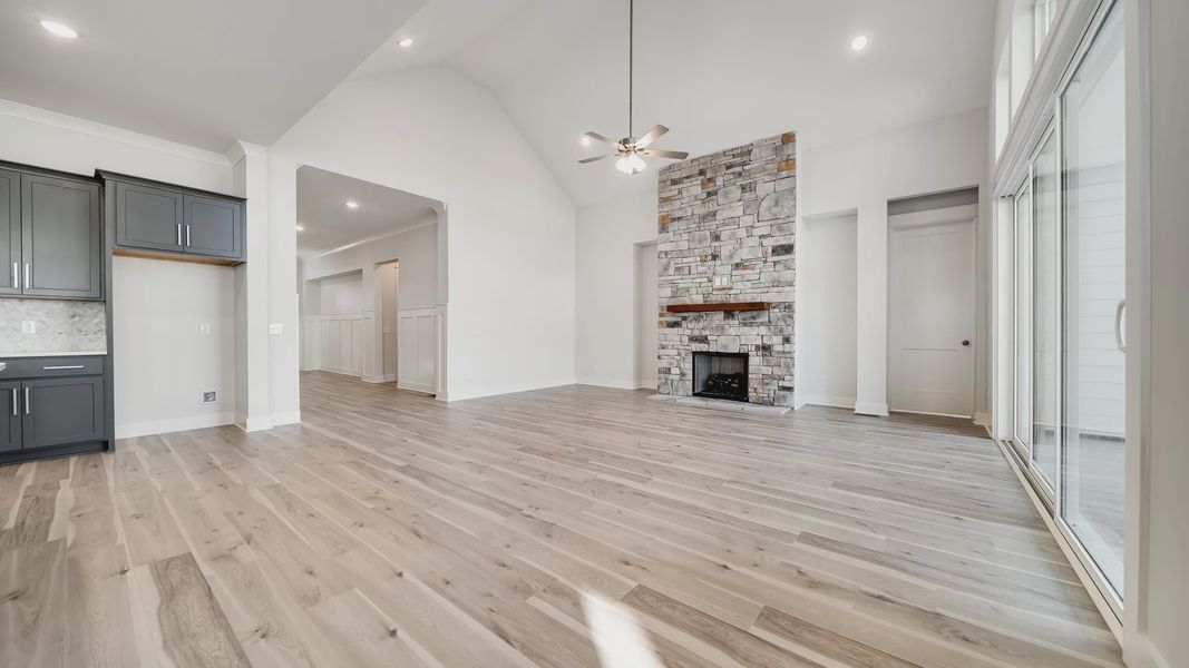 Large living room area with vaulted ceiling and stone fireplace Large living room area with vaulted ceiling and stone fireplace