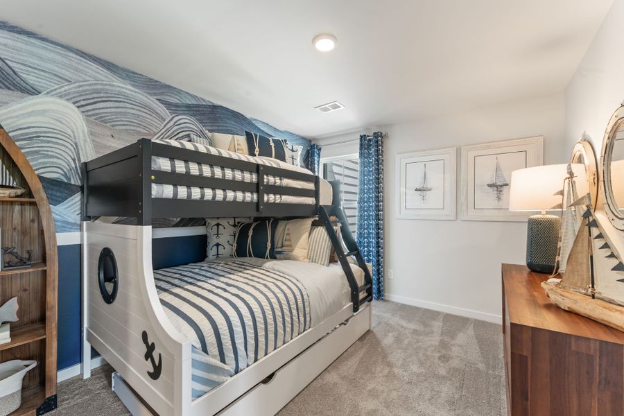 A bedroom with a bed and a mirror. A bedroom with a bed and a mirror.