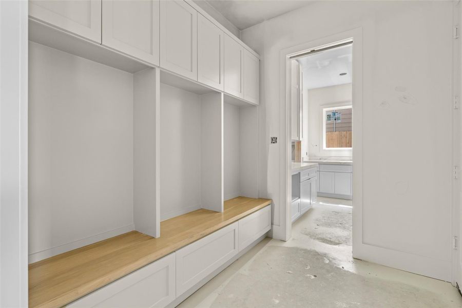 Large mudroom off garage entrance that leads into entry way and opens up to pantry for easy grocery drop off. Large mudroom off garage entrance that leads into entry way and opens up to pantry for easy grocery drop off.