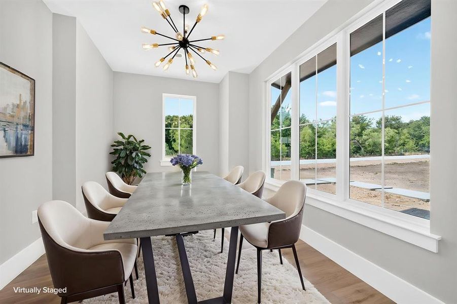 Sun-drenched home office or dinning room featuring expansive windows that invite abundant natural light. Sun-drenched home office or dinning room featuring expansive windows that invite abundant natural light.