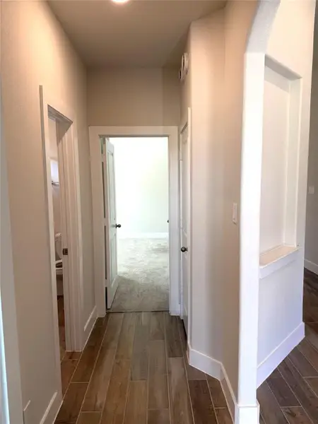 Thoughtfully designed hallway connects bedrooms, full bath & convenient storage.