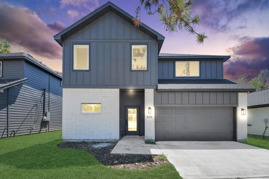 Front Exterior – Attractive new construction with modern exterior finishes, concrete driveway, and attached 2-car garage.
