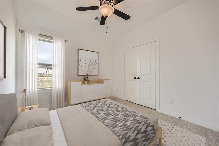 Virtually staged photo - Carpeted bedroom featuring vaulted ceiling, ceiling fan, and a closet Virtually staged photo - Carpeted bedroom featuring vaulted ceiling, ceiling fan, and a closet