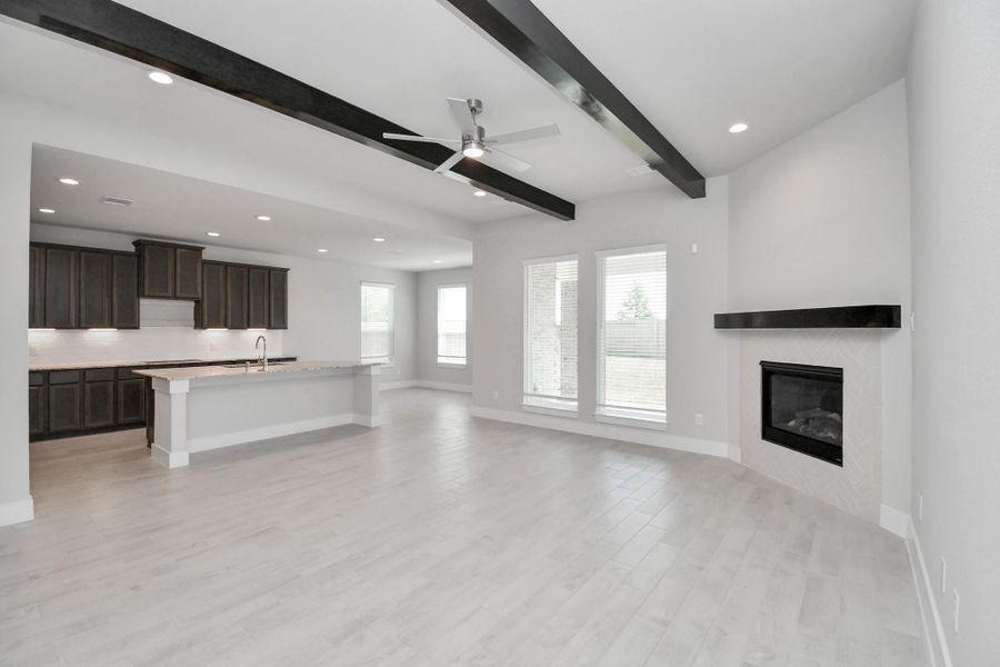 Gather the family and guests together in your lovely living room! Featuring soaring high ceilings, recessed lighting, ceiling fan, custom paint, gorgeous floors, and large windows that provide plenty of natural lighting throughout the day. Sample photo of completed home with similar floor plan. Actual colors and selections may vary. Gather the family and guests together in your lovely living room! Featuring soaring high ceilings, recessed lighting, ceiling fan, custom paint, gorgeous floors, and large windows that provide plenty of natural lighting throughout the day. Sample photo of completed home with similar floor plan. Actual colors and selections may vary.