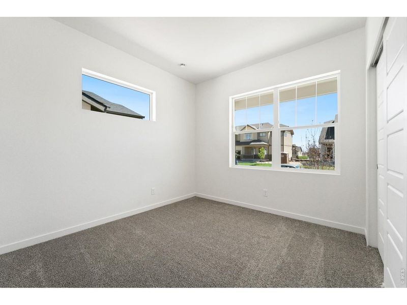 Spacious, unfurnished interior of a new home in Union Colony West, Greeley (Image 22).