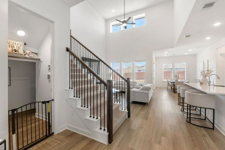 Entrance foyer featuring visible vents, stairway, baseboards, and light wood-style floors